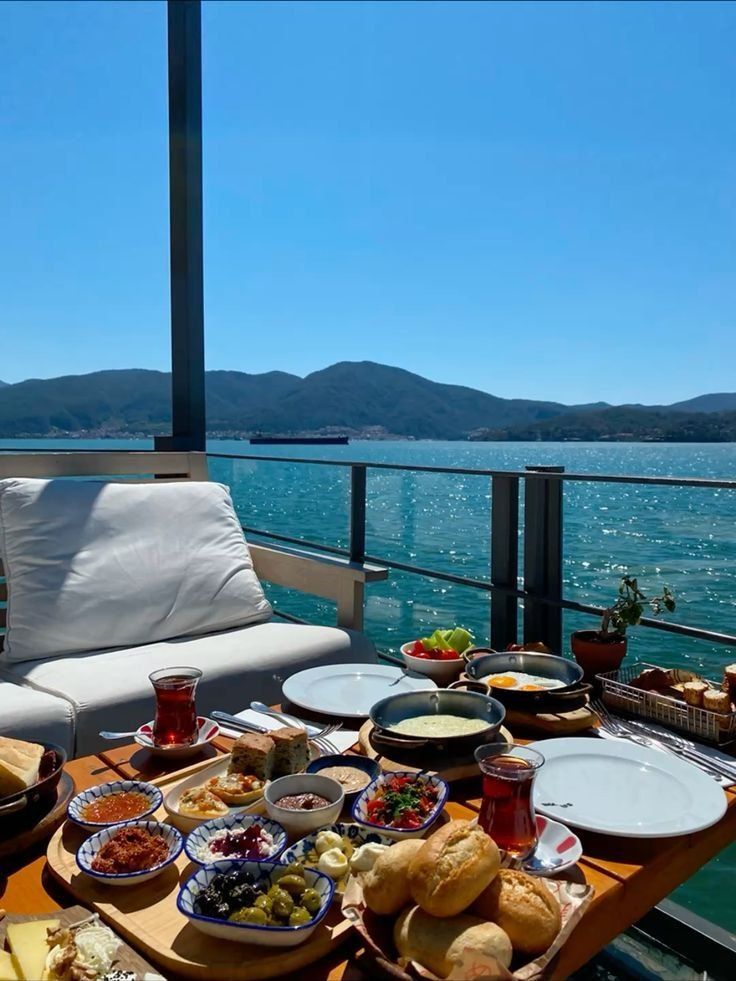 A spread of Turkish mezze and tea on a terrace table above the bay